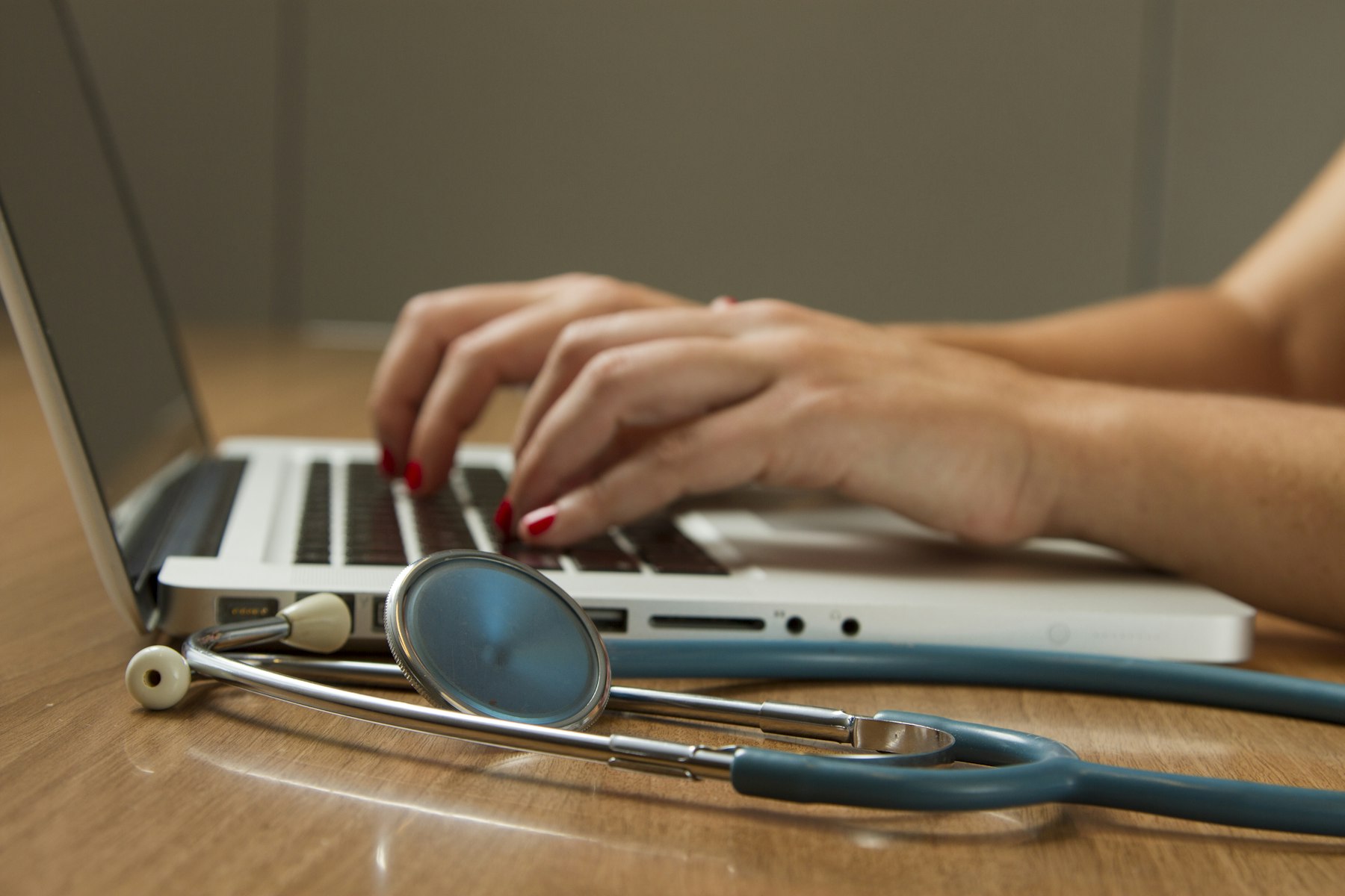 Clinical team collaborating with digital records nearby